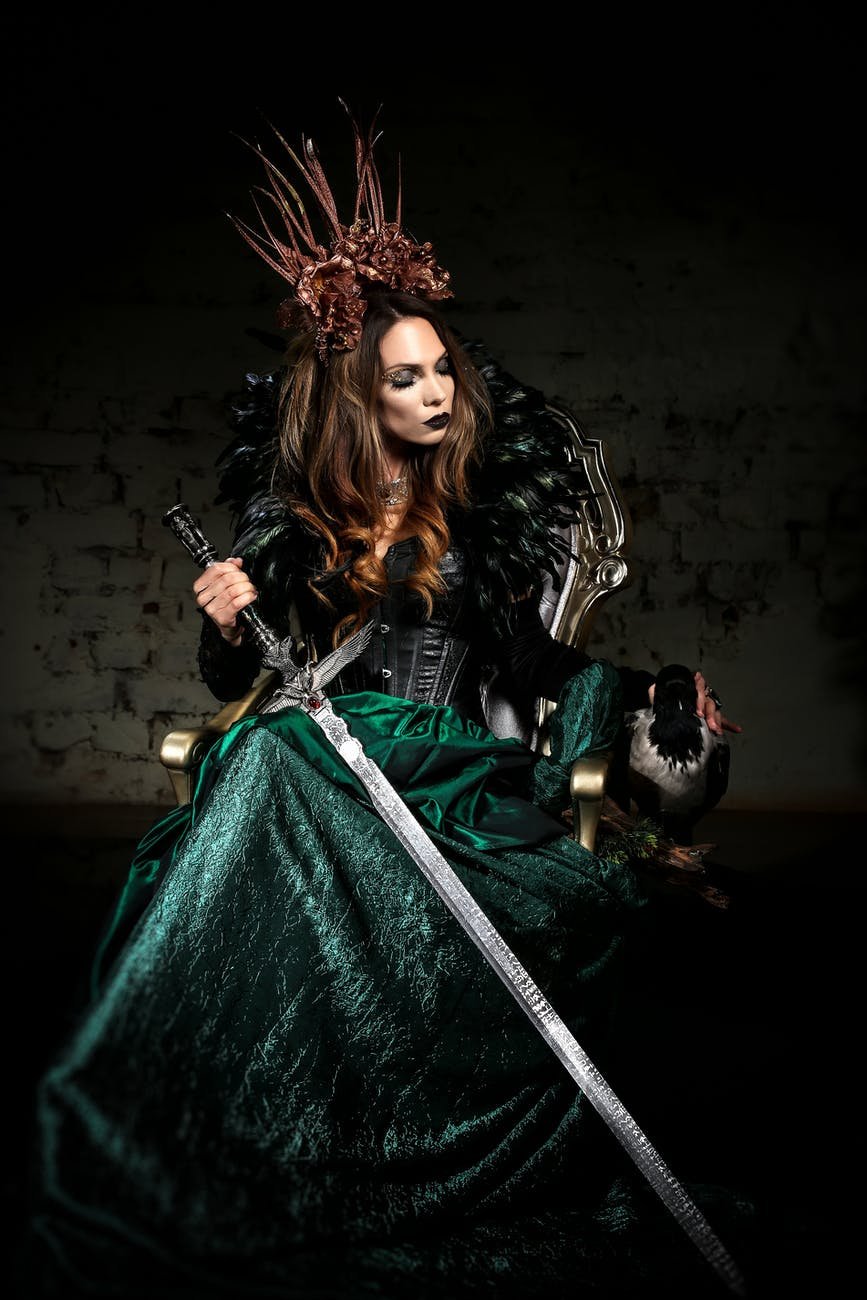 woman wearing a costume holding a sword